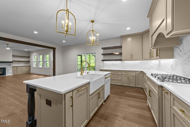 525 Allesandra Dr, Clayton, NC 27527 - kitchen featuring stainless steel gas cooktop, open shelves, light countertops, a chandelier, and a sink