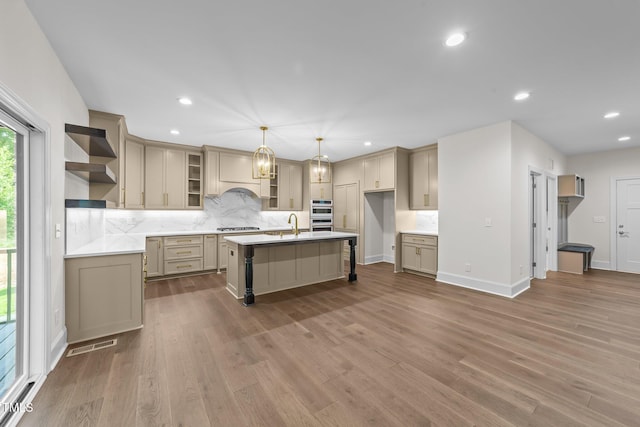 525 Allesandra Dr, Clayton, NC 27527 - kitchen featuring open shelves, decorative backsplash, a kitchen island with sink, recessed lighting, and dark wood-type flooring