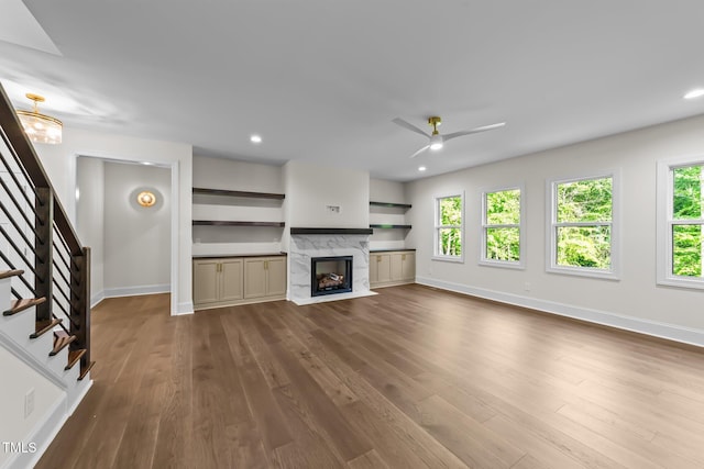 525 Allesandra Dr, Clayton, NC 27527 - unfurnished living room featuring stairway, healthy amount of natural light, dark wood finished floors, baseboards, and recessed lighting
