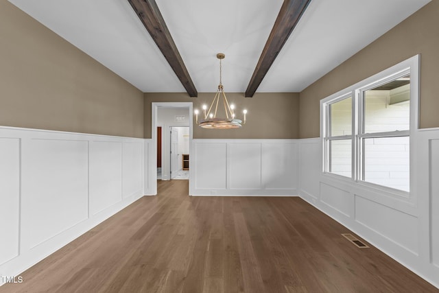 525 Allesandra Dr, Clayton, NC 27527 - unfurnished dining area featuring a chandelier, a decorative wall, wood finished floors, a wainscoted wall, and beam ceiling