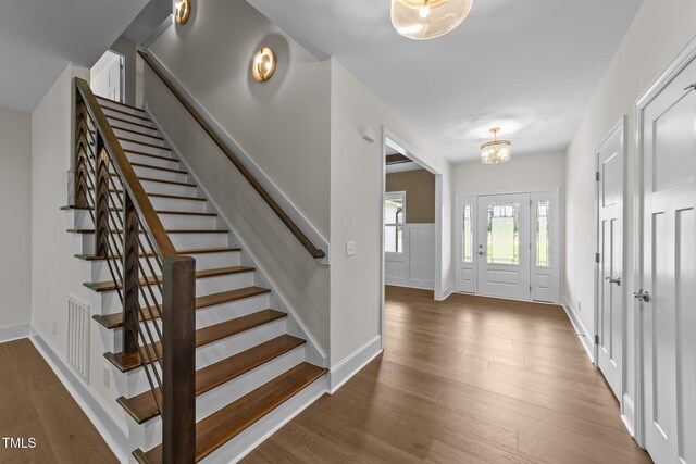 525 Allesandra Dr, Clayton, NC 27527 - entrance foyer featuring stairway, wood finished floors, a chandelier, and baseboards