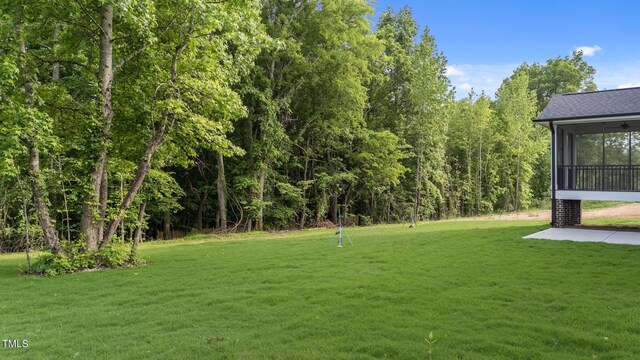 525 Allesandra Dr, Clayton, NC 27527 - view of grassy yard featuring a sunroom and a patio area