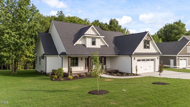 525 Allesandra Dr, Clayton, NC 27527 - modern farmhouse style home featuring a porch, driveway, a front lawn, an attached garage, and board and batten siding