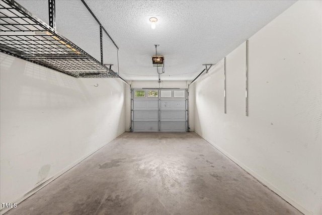 garage featuring a garage door opener and baseboards