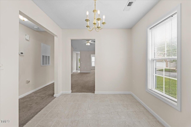 unfurnished room with a chandelier, baseboards, light colored carpet, and ceiling fan