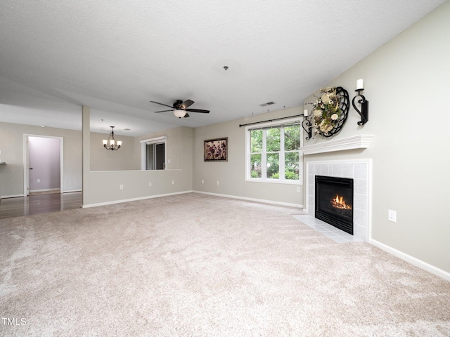 1911 Falls Landing Dr Unit 106, Raleigh, NC 27614 - unfurnished living room featuring carpet, a fireplace, ceiling fan, and a chandelier