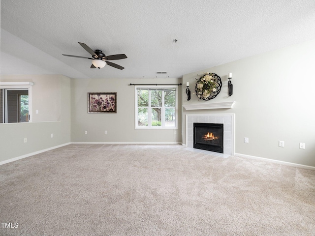 1911 Falls Landing Dr Unit 106, Raleigh, NC 27614 - unfurnished living room featuring a textured ceiling, a tile fireplace, ceiling fan, carpet flooring, and baseboards