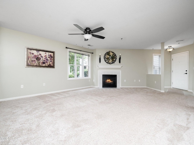 1911 Falls Landing Dr Unit 106, Raleigh, NC 27614 - unfurnished living room featuring a ceiling fan, a tile fireplace, baseboards, and light carpet