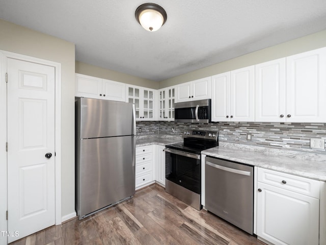 1911 Falls Landing Dr Unit 106, Raleigh, NC 27614 - kitchen featuring stainless steel appliances, dark wood finished floors, decorative backsplash, and white cabinets