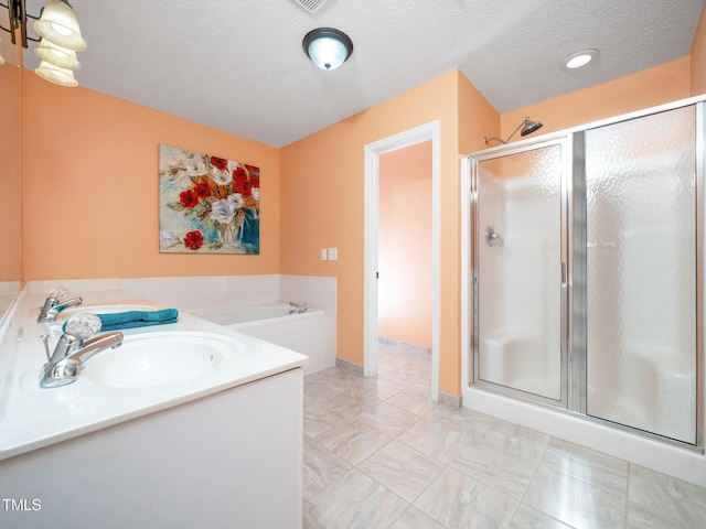 1911 Falls Landing Dr Unit 106, Raleigh, NC 27614 - bathroom featuring a sink, a shower stall, a garden tub, a textured ceiling, and marble look tile flooring