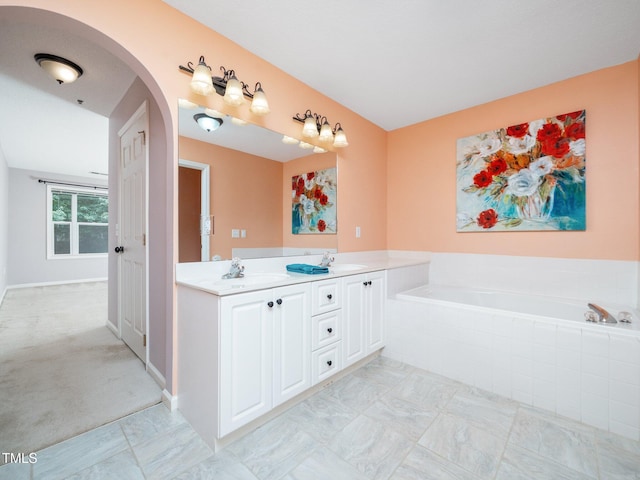 1911 Falls Landing Dr Unit 106, Raleigh, NC 27614 - bathroom with double vanity, a bath, and baseboards