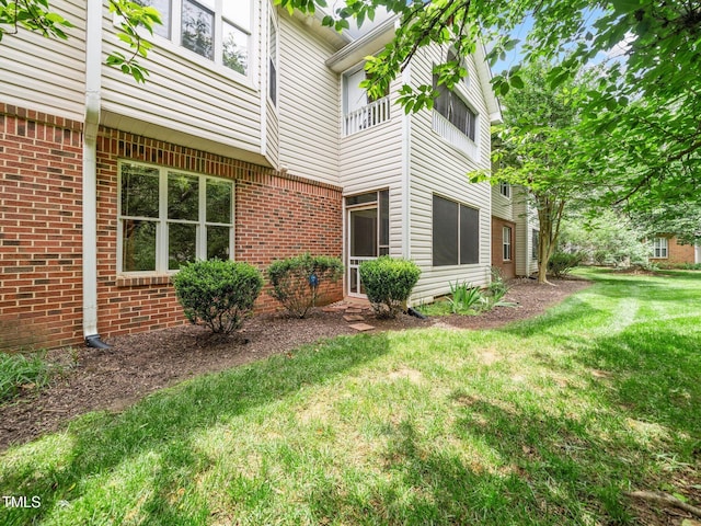 1911 Falls Landing Dr Unit 106, Raleigh, NC 27614 - view of home's exterior featuring a lawn and brick siding