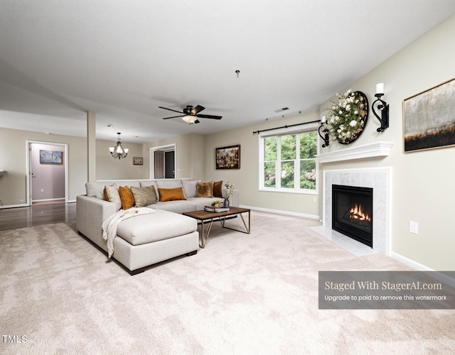 1911 Falls Landing Dr Unit 106, Raleigh, NC 27614 - living area featuring carpet, a tiled fireplace, baseboards, ceiling fan, and a chandelier