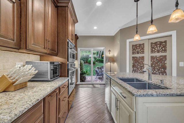 4802 Glenmist Ct, Raleigh, NC 27612 - kitchen featuring a sink, appliances with stainless steel finishes, tasteful backsplash, light stone counters, and crown molding