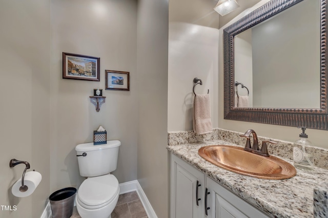 4802 Glenmist Ct, Raleigh, NC 27612 - bathroom with baseboards, toilet, vanity, and tile patterned flooring