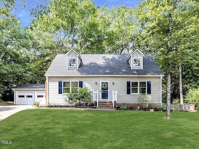 113 Honeysuckle Ln, Durham, NC 27703 - cape cod house featuring a front yard, a garage, a shingled roof, and an outbuilding