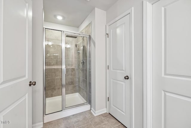 209 White Farm Dr, Wendell, NC 27591 - bathroom featuring a shower stall, tile patterned flooring, and baseboards