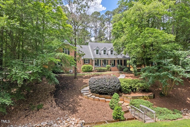 new england style home with brick siding