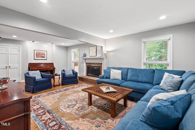 living area featuring wood finished floors, recessed lighting, and a fireplace