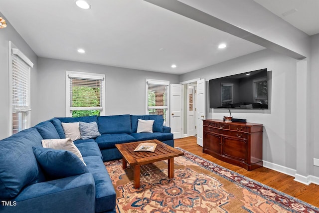 living area with wood finished floors, recessed lighting, and baseboards