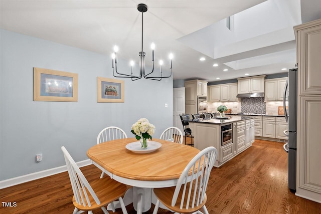 dining space with wood finished floors, a chandelier, recessed lighting, and baseboards