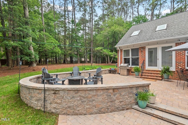 view of patio / terrace featuring an outdoor fire pit, french doors, entry steps, and area for grilling