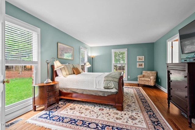 bedroom with wood finished floors and baseboards