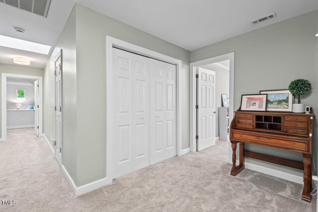 hall with carpet flooring and baseboards