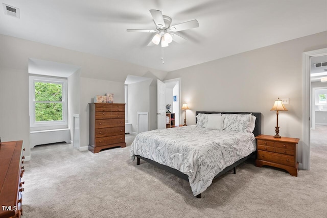 bedroom with light carpet, baseboards, vaulted ceiling, and a ceiling fan