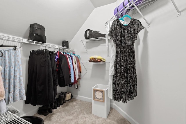 spacious closet with carpet flooring and lofted ceiling