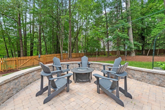 view of patio featuring a fire pit and a fenced backyard