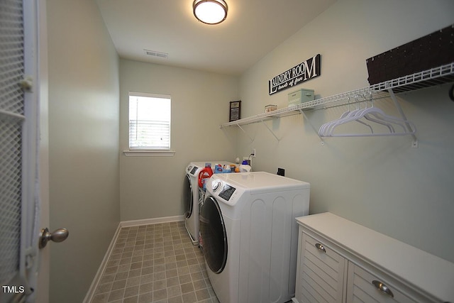 clothes washing area featuring independent washer and dryer and baseboards