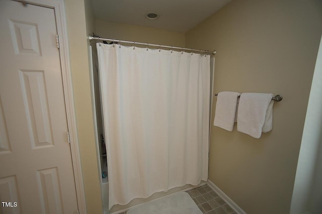 full bathroom featuring tile patterned floors and baseboards