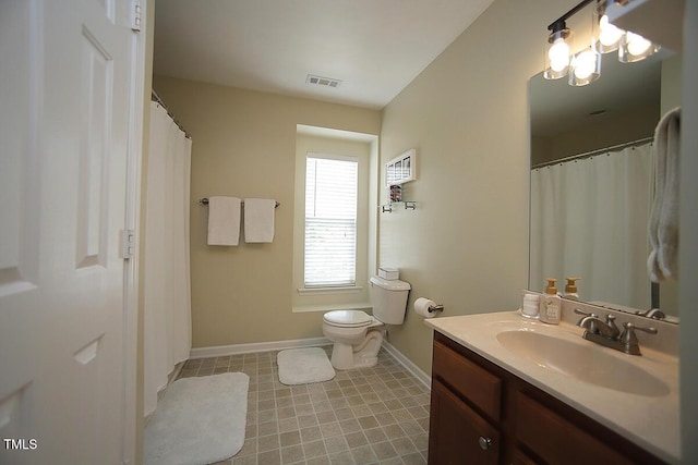 full bath with baseboards, vanity, and toilet