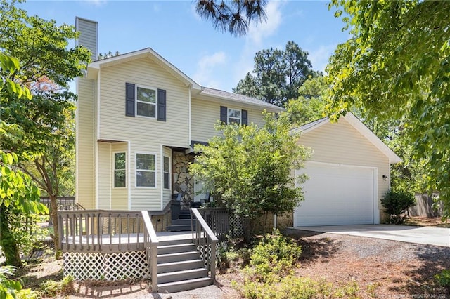 70 Oregon Ln, Spring Lake, NC 28390 - view of front of property featuring driveway, a chimney, and an attached garage