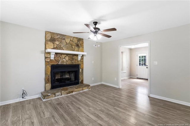 70 Oregon Ln, Spring Lake, NC 28390 - unfurnished living room featuring ceiling fan, wood finished floors, baseboards, and a fireplace