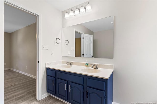70 Oregon Ln, Spring Lake, NC 28390 - bathroom with double vanity, wood finished floors, and baseboards