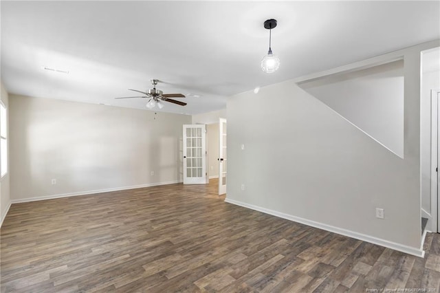 70 Oregon Ln, Spring Lake, NC 28390 - unfurnished living room with dark wood-type flooring, a ceiling fan, and baseboards