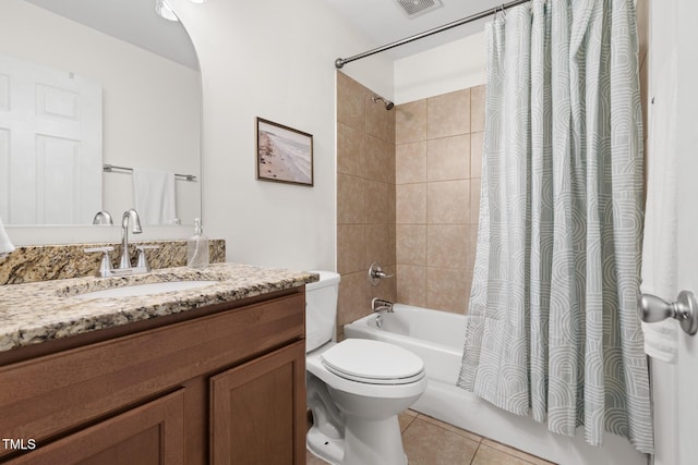 bathroom with shower / tub combo with curtain, tile patterned flooring, toilet, and vanity