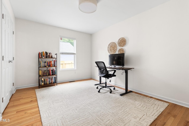 office space featuring light wood-style floors and baseboards