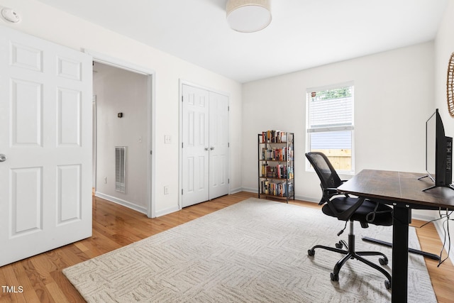 office area with light wood-type flooring and baseboards