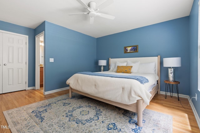 bedroom featuring wood finished floors, baseboards, and a ceiling fan