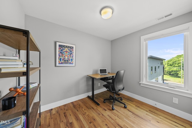 home office with wood finished floors and baseboards