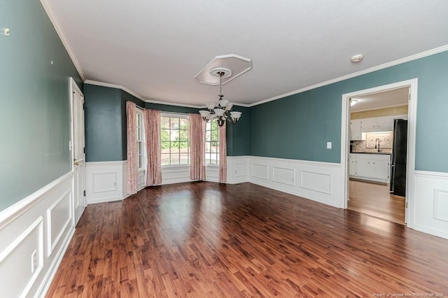 225 Lakeview Dr, Sanford, NC 27332 - spare room with a chandelier, ornamental molding, a wainscoted wall, a decorative wall, and wood finished floors