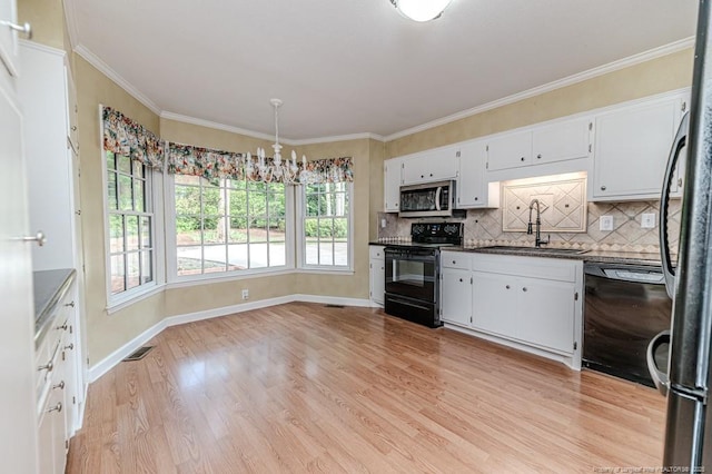 225 Lakeview Dr, Sanford, NC 27332 - kitchen featuring black appliances, a sink, dark countertops, light wood-type flooring, and baseboards