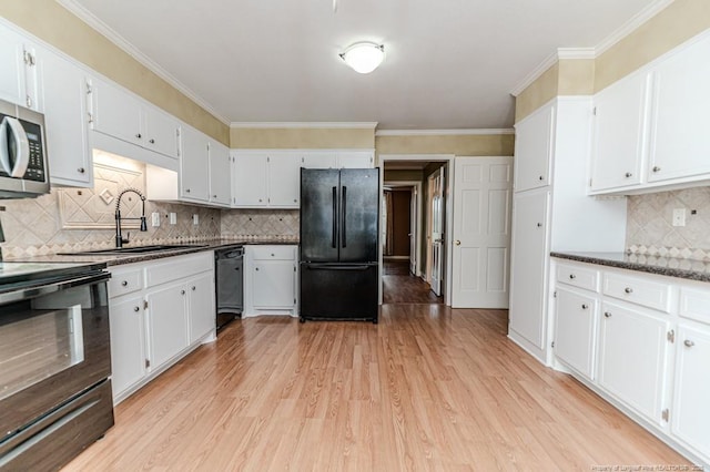 225 Lakeview Dr, Sanford, NC 27332 - kitchen with black appliances, a sink, light wood-type flooring, backsplash, and white cabinets