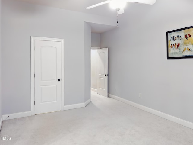 unfurnished bedroom with carpet flooring, baseboards, and ceiling fan
