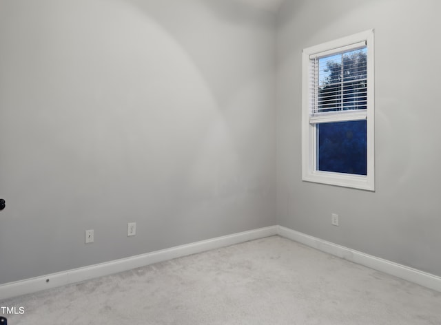 empty room with carpet and baseboards