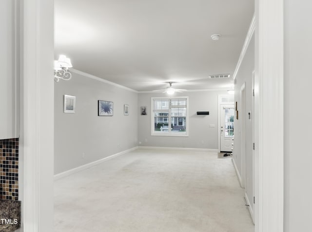 empty room featuring crown molding, light colored carpet, ceiling fan, and baseboards