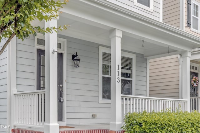 doorway to property with covered porch